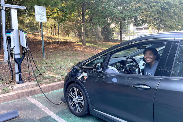 student using electric car charger at library in Athens Georgia