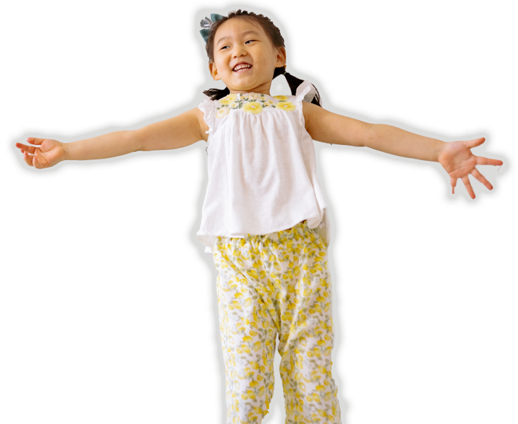 girl jumping in the air with arms wide open